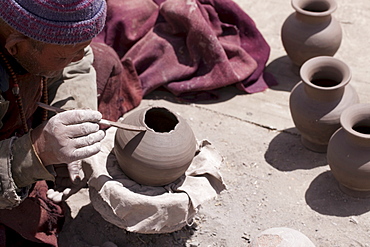 Skalzang Norbu, 69, hand-builds "bumpa", or ritual vases, outside his home in Likir. Ladakh, India