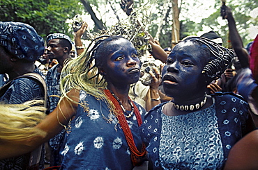 Yoruba women dance in trance at a sacred water festival to honor their animistic spirits. nigeria, africa