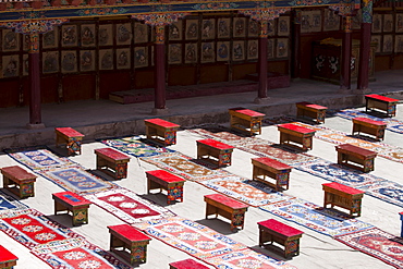 Tibetan interior: Tea tables and carpets arranged in the courtyard for a ceremony at Hemis Monastery. Ladakh, India