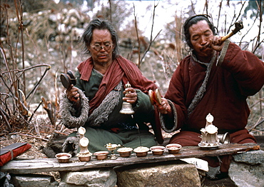 Nepal. Sonam & boom praying at charnel grounds. Humla. Vajrayana is tantric mahasiddha, lives fearlessly in terrifying places like remote jungles charnel grounds. nyingma lamas perform ritual at cremation grounds. lama rattles damaru, a small ritual drum to have origins in - shamanism. damaru, used as a tantric device to summon gods ward evil spirits, once made from human skull bones dried human skin as a reminder of impermanence of body. other lama, boom blows a kangling, a human thigh-bone horn. kangling is used in exorcism is capable of gods demons. Traditionally, best bones a kangling come from brahmans, particularly sixteen-year- brahman girls-or from tigers