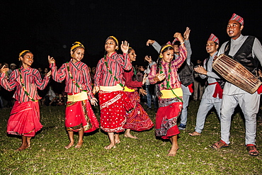 Nepali girls wearing chaubandi cholo (blouse) and fariya (skirt) dancing to the tunes of Nepali folk songs, Assam, India, Asia