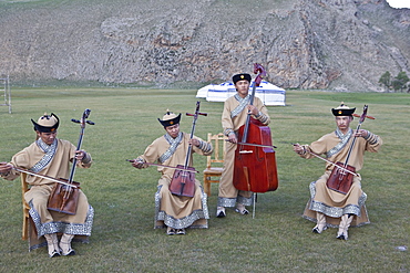 Local band play Mongolia's National instrument, the Morin khuur (horse head fiddle) and perform Khoomi, throat singing, Bunkhan, Mongolia, Central Asia, Asia