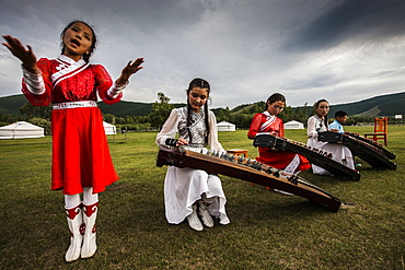 Concert at Lapis Sky Ger camp, young girls play Yatga-Yatuga (string instrument) at Bunkhan, Mongolia, Central Asia, Asia