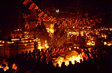 Monks offer butter lamps. Bodgaya, india. Monks offer butter lamps in front of mahabodhi temple marks site of buddha’s enlightment twenty-five hundred years. centuries have made pilgrimages across himalayas to sites connected with life of historical buddha. From a tantric perspective, pilgrimage is more than paying homage at sacred sites. Rather, it is that activities performed at these places become a memory of place itself. By attuning oneself through ritual meditation to this timeless presence, similar experiences be evoked