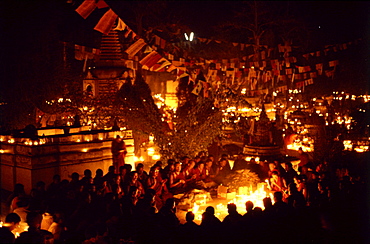 Monks offer butter lamps. Bodgaya, india. Monks offer butter lamps in front of mahabodhi temple marks site of buddhaâ€šÃ„Ã´s enlightment twenty-five hundred years. centuries have made pilgrimages across himalayas to sites connected with life of historical buddha. From a tantric perspective, pilgrimage is more than paying homage at sacred sites. Rather, it is that activities performed at these places become a memory of place itself. By attuning oneself through ritual meditation to this timeless presence, similar experiences be evoked