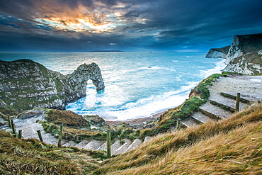 A winter sunset at Durdle Door on the Jurassic Coast, UNESCO World Heritage Site, Dorset, England, United Kingdom, Europe