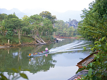 Outboard powered longboat on the Melinau River, Mulu National Park, Sarawak, island of Borneo, Malaysia, Southeast Asia, Asia