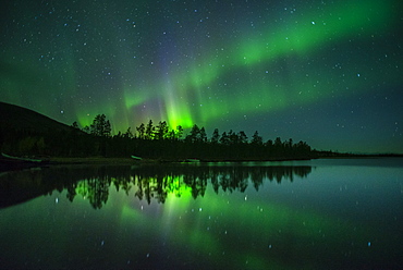 Aurora Borealis and stars over lake at night, Muonio, Lapland, Finland, Scandinavia, Europe