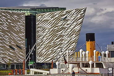 A view of the Titanic Museum, with the SS Nomadic, the only surviving White Star Line ship, in the Titanic Quarter, Belfast, Ulster, Northern Ireland, United Kingdom, Europe