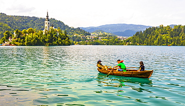 A boat on Lake Bled with the Church of the Assumption in the background, Lake Bled, Slovenia, Europe