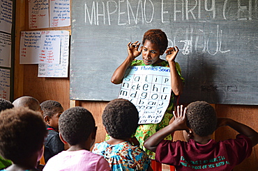 Early childhood teacher teaching a whole class phonics session at Mapemo early learning centre in Goroka, Papua New Guinea, Pacific