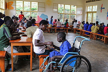 Raphael Tuyizere,15 years old, being fed by his mother Priscilla Tuyisenge from Ngwino Nawe, Rwanda, Africa