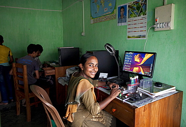 Habiba Akhter, aged 18, a member of a youth club in Afcalpur village, repairing mobile phones, Rangpur District of North West Bangladesh, Asia