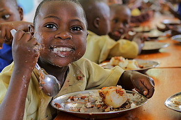 Ndayisabye John 7 years from Ngwino Nawe village is intellectually disabled, having sweet potatoes and beans for lunch, Rwanda, Africa