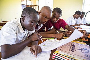 Children studying during a class taken by VSO volunteer Paul Jennings and local teacher Rebecca Ngovano, Angaza school, Lindi, Tanzania, East Africa, Africa