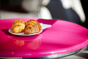 Croissants on a pink cafe table, Paris, France, Europe