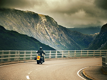 Harley Davidson biker crossing the Kylesku Bridge, Scotland, United Kingdom, Europe