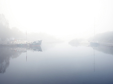 boats in the mist on the river Shannon at Lough Derg, Portumna, Co Galway, Republic of Ireland, Europe