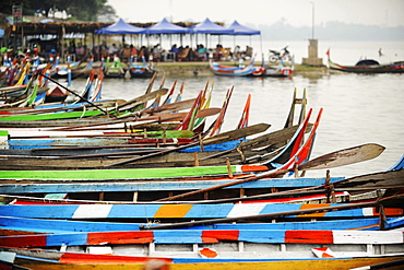 Brightly coloured boats at the U Bein Bridge, Taungthaman Lake, Amarapura near Mandalay, Myanmar (Burma), Asia