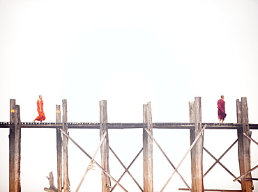 Monk crossing the U Bein Bridge, Taungthaman Lake, Amarapura near Mandalay, Myanmar (Burma), Asia