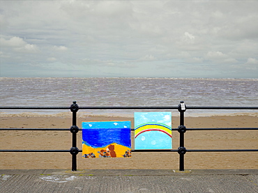 Optimistic paintings tied to railings on a drab British summer day, United Kingdom, Europe