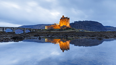 Dusk at Eilean Donan (Eilean Donnan) Castle in Dornie, Highlands, Scotland, United Kingdom, Europe