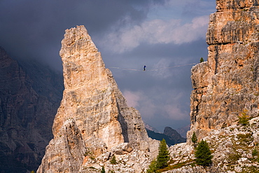 Adventure seeker high wire walking in Cinque Torri, Belluno, Dolomites, Italy, Europe