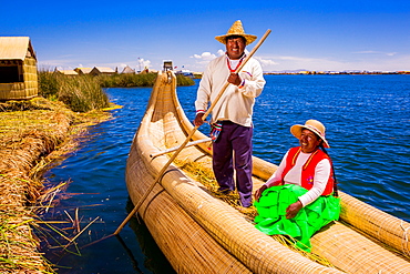 Quechua Indian couple on Floating Grass islands of Uros, Lake Titicaca, Peru, South America