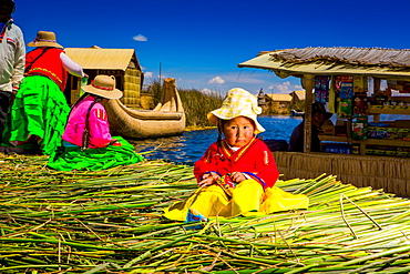 Little Quechua girl on Floating Grass islands of Uros, Lake Titicaca, Peru, South America