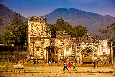 Kids playing soccer at ruins in Antigua, Guatemala, Central America