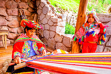 Quechua woman from the Accha Huata, Bombom, and Paucartambo communities working her loom, Sacred Valley, Peru, South America