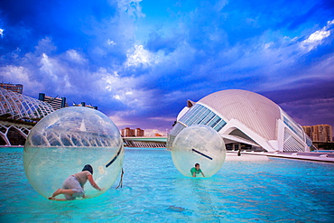 Kids playing in floating orbs, Hemispheric Buildings, City of Arts and Sciences, Valencia, Spain, Europe