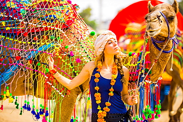 Laura Grier with camel at the Pushkar Camel Fair, Pushkar, Rajasthan, India, Asia