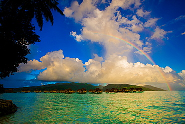 Rainbow arcing over the overwater bungalows, Le Taha'a Resort, Tahiti, French Polynesia, South Pacific, Pacific