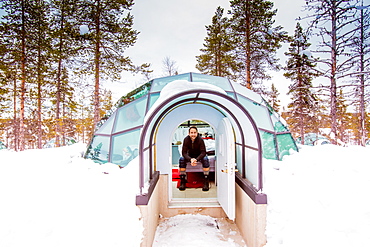 Man sitting inside igloo, Kakslauttanen Igloo Village, Saariselka, Finland, Scandinavia, Europe