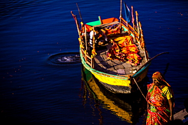 Woman tying up her boat, The Flower Holi Festival, Vrindavan, Uttar Pradesh, India, Asia