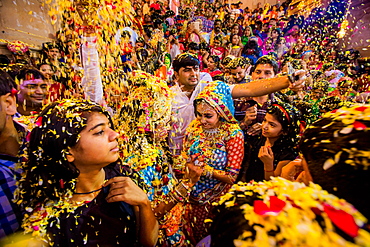 Crowd throwing flower petals during the Flower Holi Festival, Vrindavan, Uttar Pradesh, India, Asia