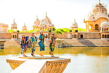 Female tourists stand in front of Temple during Holi Festival, Vrindavan, Uttar Pradesh, India, Asia