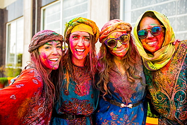 Tourists covered in pigment during the Holi Festival, Vrindavan, India, Asia