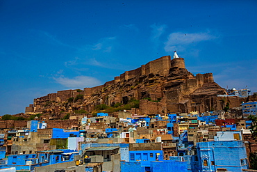 Mehrangarh Fort towering over the blue rooftops in Jodhpur, the Blue City, Rajasthan, India, Asia