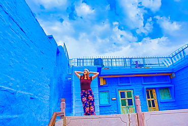 Woman stands on the blue rooftop of Rani Mahal Hotel, in Jodhpur, the Blue City, Rajasthan, India, Asia