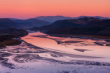 Twilight and low tide on the calm Mawddach estuary bordered by the mountains within Snowdonia National Park, Gwynedd, Wales, United Kingdom, Europe