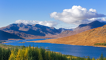 The road to the Scottish Highlands passing Loch Loyne and the distant mountains, Scotland, United Kingdom, Europe