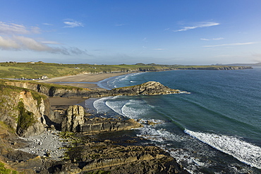 Waves gently roll into Whitesands Bay (Porth Mawr) on a summers evening along the Pembrokeshire coastal path, Wales, United Kingdom, Europe