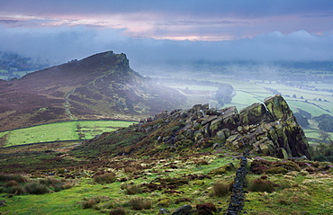 Morning mist and fog clear the landscape to reveal Hen Cloud and the gritstone rocks of the Roaches, Peak District, Derbyshire, England, United Kingdom, Europe