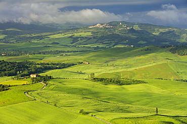 Looking across the Val d'Orcia to the historic towns of Rocca d'Orcia and Castiglione d'Orcia with clouds lingering beyond, UNESCO World Heritage Site, Tuscany, Italy, Europe