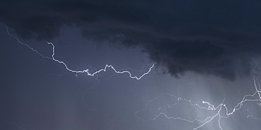 Multiple strikes of forked and intracloud lightning coming from the sky during a summer thunderstorm, Cheshire, England, United Kingdom, Europe