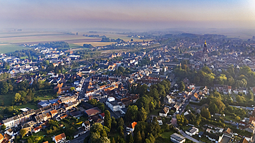 Looking north above the city of Albert. The golden virgin sculpture atop of the Basilica Notre Dame de Brebiers is lit by the morning light. Futher beyond the Somme countryside merges into the distant fog.