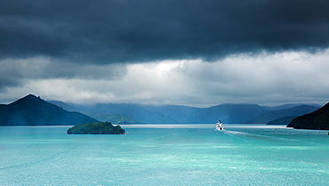 The narrow passageway of Queen Charlotte Sound with a ferry boat navigating its way through to the Cook Straits, Marlborough, South Island, New Zealand, Pacific