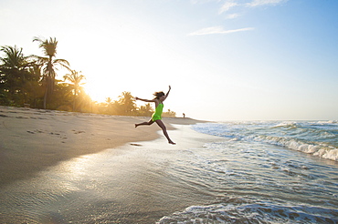 A girl plays in the waves at Palomino on the Caribbean coast of Colombia, South America